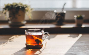 blur, close-up, cup, drink, glass, hot, smoke, table, tea, teacup, warmly, fume