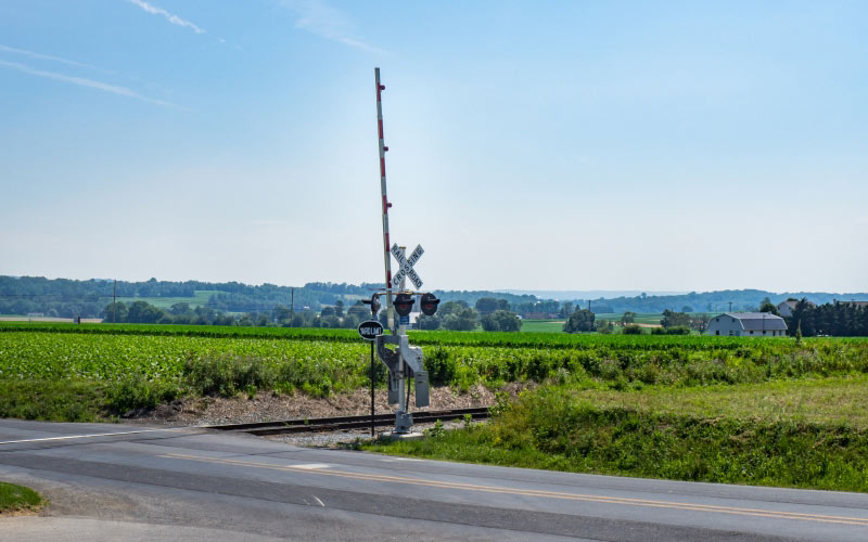 blue sky, farm, field, green, landscape, railroad, rural, summer, road, gate, barrier, countryside