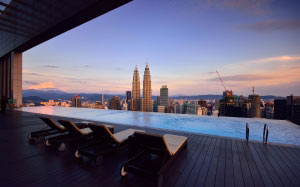 lounge chair, swimming, pool, buildings, chairs, city, cityscape, dawn, dusk, kuala lumpur, landmark, leisure, malaysia, petronas towers, sky, skyline, sunset, swimming pool, water, architecture, skyscraper, urban skyline, tower, landscape, financial district, 